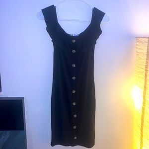 Women’s black form-fitting dress with buttons.